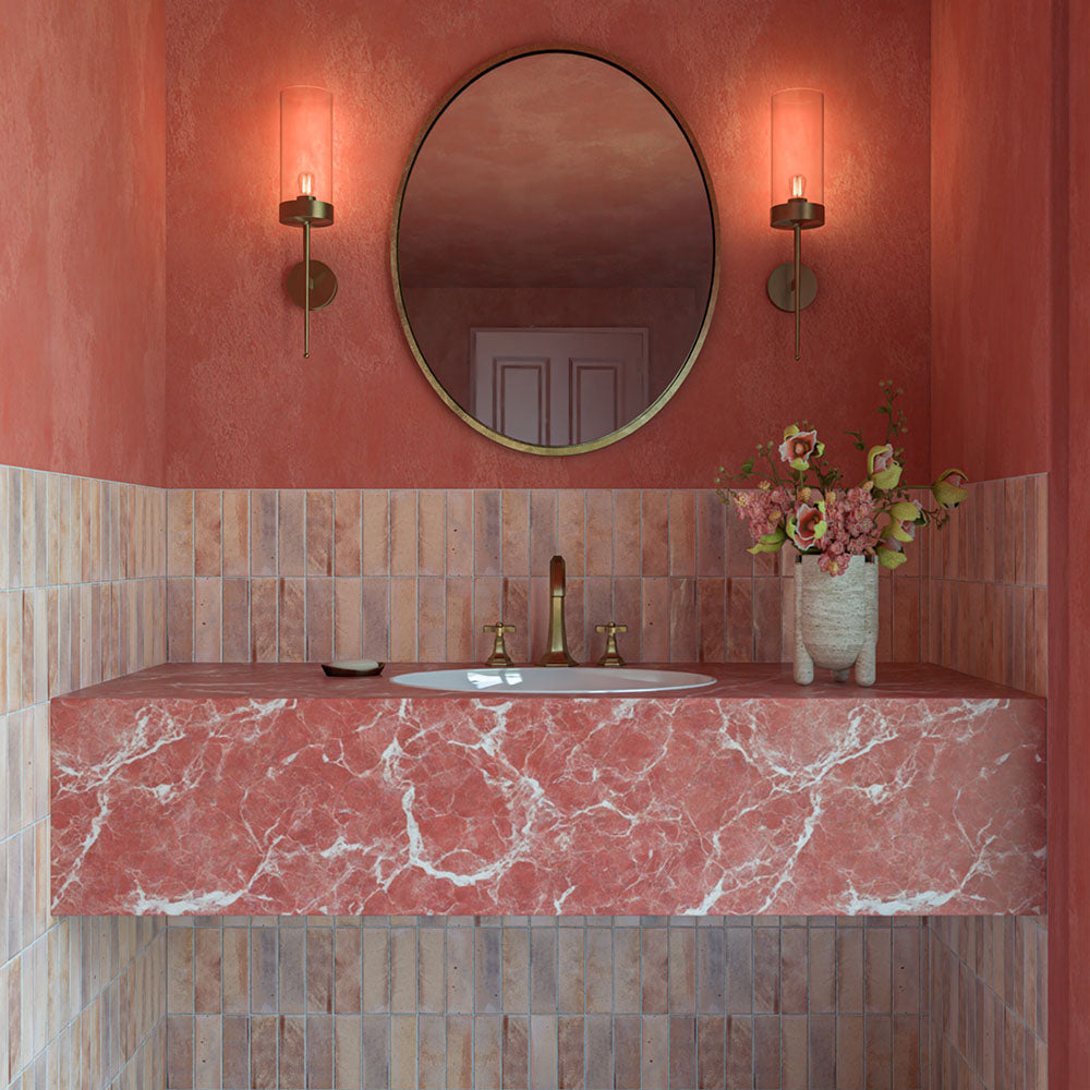 Beijing Rose Pink Brick 5.1cm x 16.1cm Moroccan style wall tiles, featuring soft pink tonal variation in a warm bathroom with coral walls, and a pink marble vanity.