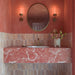 Beijing Rose Pink Brick 5.1cm x 16.1cm Moroccan style wall tiles, featuring soft pink tonal variation in a warm bathroom with coral walls, and a pink marble vanity.