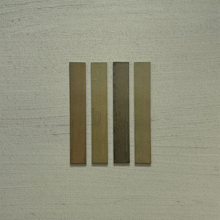 Close-up of Belem Olive Green 5cm x 30cm artisanal porcelain wall tiles, displaying four slim brick tiles with earthy olive green tones, subtle surface texture and gentle tonal variation.
