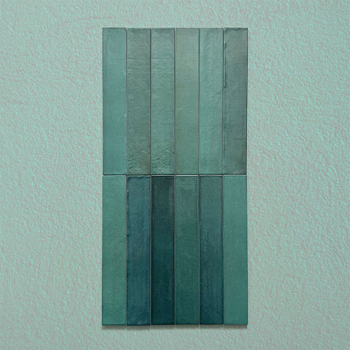 Close-up of Belem Verde Green 5cm x 30cm artisanal porcelain wall tiles, showcasing the slim brick format, rich green tones, subtle surface texture and natural-looking tonal variation.