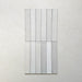 Close-up of Belem White 5cm x 30cm artisanal porcelain wall tiles arranged vertically, showcasing soft white tones, subtle tonal variation and a gently textured handcrafted-effect surface finish.