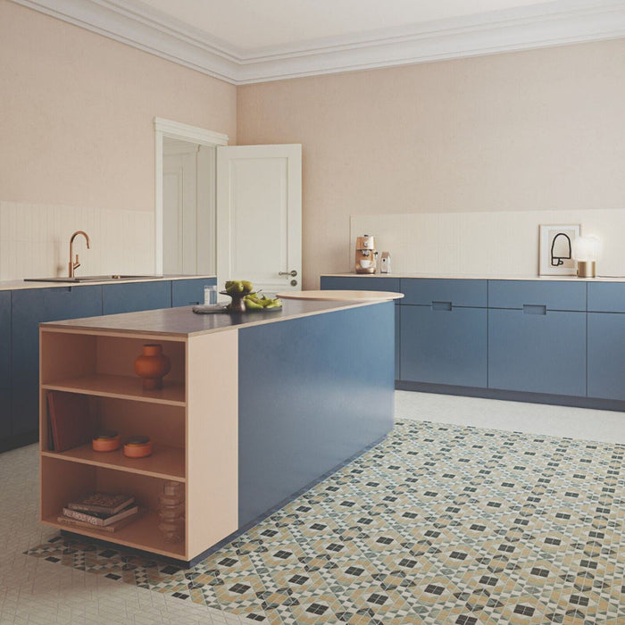 Kitchen interior featuring Belgravia Marina Plus Mosaic 28 × 28cm Victorian style patterned floor tiles, with intricate geometric detailing in blue, green and beige tones, paired with blue cabinetry, light worktops, and soft neutral walls.