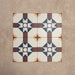 Four Europa Berlin 20x20cm Victorian Moroccan style tiles arranged together to showcase the repeating geometric star pattern in burgundy, blue, mustard and cream tones, displayed against a textured beige background.