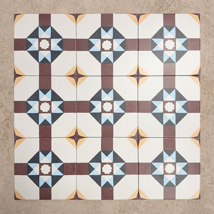 Group of Europa Berlin 20x20cm Victorian Moroccan style tiles arranged together to showcase the repeating geometric star pattern in burgundy, blue, mustard and cream tones, displayed against a textured beige background.