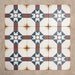 Group of Europa Berlin 20x20cm Victorian Moroccan style tiles arranged together to showcase the repeating geometric star pattern in burgundy, blue, mustard and cream tones, displayed against a textured beige background.