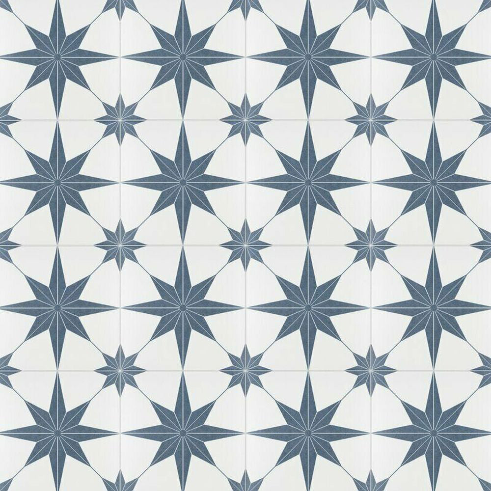 Pole Star Blue Moroccan-style 25x25cm patterned porcelain tiles arranged in a grouped layout, showcasing the repeating blue star motif on a soft white background.