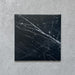 Calacatta Nero Black marble-effect 25×25cm porcelain tile featuring a deep black base with striking white veining, ideal for creating bold, elegant floors and walls in modern and classic interiors.