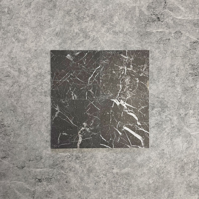 Fitzrovia Black 15.2x15.2cm honed natural marble tiles arranged in a square layout, showcasing deep charcoal tones, bold white veining, tonal variation, and a smooth, refined finish.
