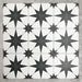 Pole Star Black Moroccan-style 25x25cm patterned porcelain tiles arranged in a grouped layout, showcasing the bold black star motif across a crisp white background.
