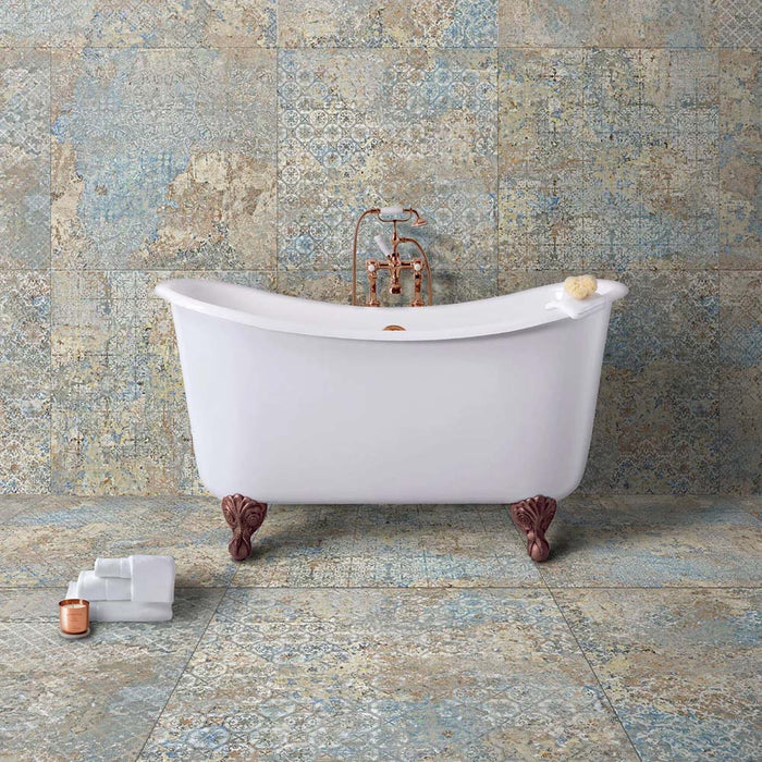 Bathroom featuring Boheme Blend 60 × 60cm patterned porcelain wall and floor tiles, showcasing a soft blend of blue, beige and aged-effect detailing. Paired with a freestanding bath and brass fittings for a relaxed, characterful finish.