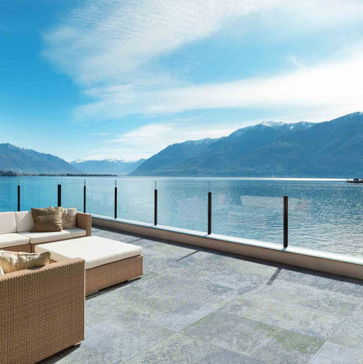 Outdoor terrace featuring Boheme Blue 2cm 50 × 100cm patterned slabs, blending soft blue and natural tones with a lightly weathered effect. Ideal for patios and outdoor living areas, creating a calm, seamless connection to the surrounding landscape.