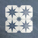 Pole Star Blue Moroccan-style 25x25cm patterned porcelain tiles arranged in a grouped layout, showcasing the repeating blue star motif on a soft white background.