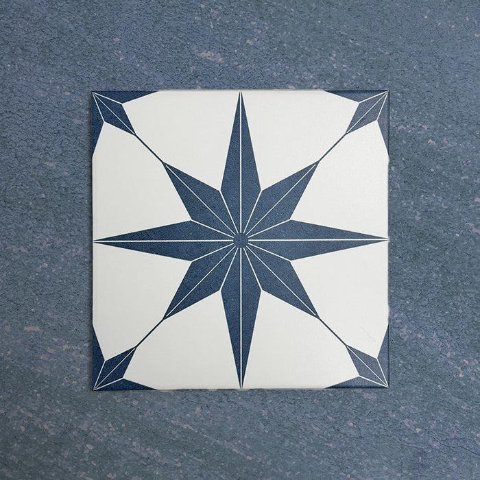 Pole Star Blue Moroccan-style 25x25cm patterned porcelain tile, featuring a bold blue star motif on a crisp white background.