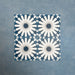 Group of Soukaina Blue B Moroccan-style 20cm x 20cm patterned porcelain tiles, showing a repeating central star design in deep blue, white and soft grey tones with a matt finish.