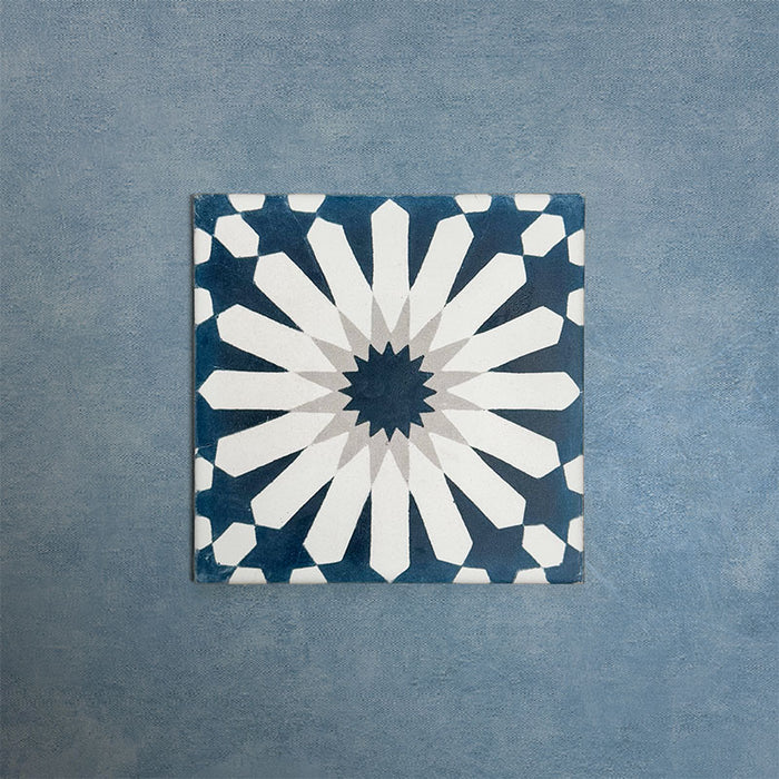 Soukaina Blue B 20cm x 20cm Moroccan-style patterned porcelain tile, featuring a bold central star motif in deep blue, white and soft grey tones with a matt finish.