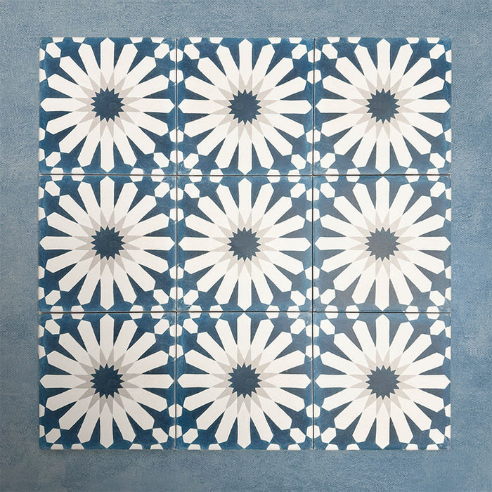 Group of Soukaina Blue B Moroccan-style 20cm x 20cm patterned porcelain tiles, showing a repeating central star design in deep blue, white and soft grey tones with a matt finish.