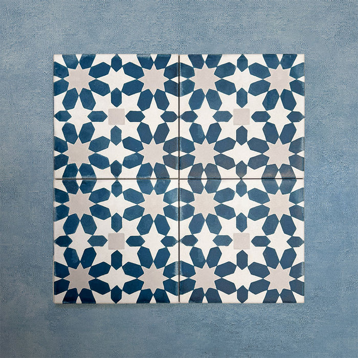 Group of Soukaina Blue C Moroccan-style 20cm x 20cm patterned porcelain tiles, showing a repeating geometric star pattern in deep blue and soft neutral tones with a matt finish.