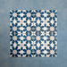 Group of Soukaina Blue C Moroccan-style 20cm x 20cm patterned porcelain tiles, showing a repeating geometric star pattern in deep blue and soft neutral tones with a matt finish.