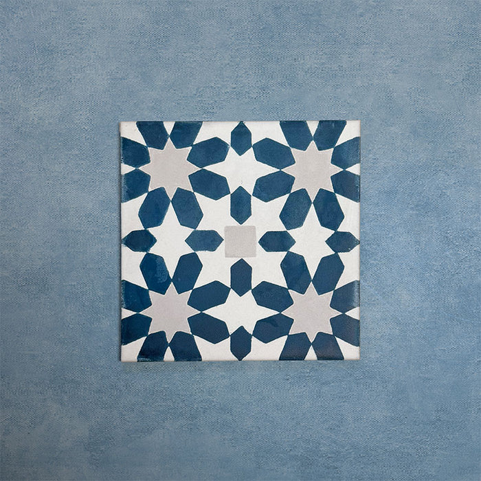 Soukaina Blue C 20cm x 20cm Moroccan-style patterned porcelain tile, featuring a repeating geometric star motif in deep blue and soft neutral tones with a matt finish.