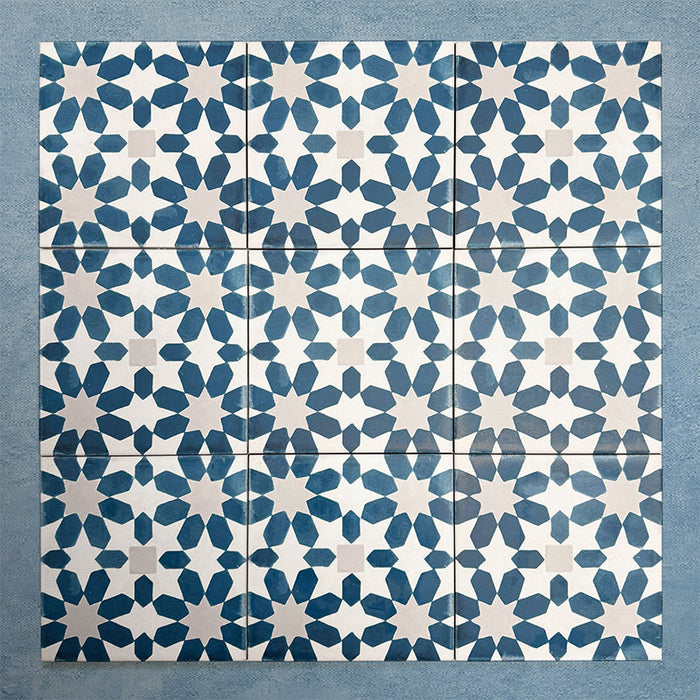 Group of Soukaina Blue C Moroccan-style 20cm x 20cm patterned porcelain tiles, showing a repeating geometric star pattern in deep blue and soft neutral tones with a matt finish.