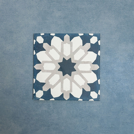 Soukaina Blue D 20cm x 20cm Moroccan-style patterned porcelain tile, featuring a bold central star motif in deep blue, white and soft neutral tones with a matt finish.