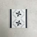 Georgetown Star Border Victorian-style 20x20cm patterned porcelain tile, featuring a monochrome star motif with contrasting black and grey border detailing.