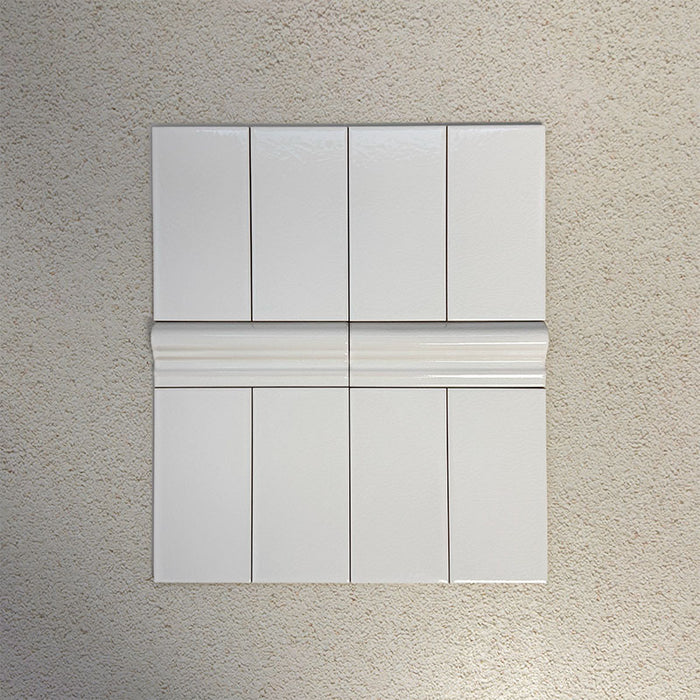 Flat lay showing Finchley White 7.5 × 15cm ceramic wall tiles with a crackle glaze finish, paired with matching 5 × 15cm dado trim to create a decorative, classic brick-style wall tile layout.