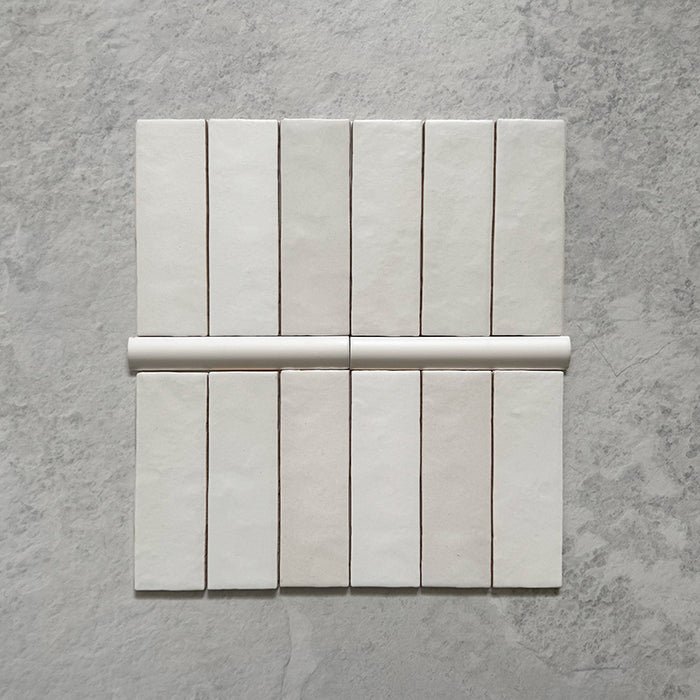 Zellij Chalk White Bullnose Moroccan-style trims in a 3cm x 20cm format, featuring a soft matt white finish and smooth rounded profile, displayed as a flat lay on a neutral stone-effect background.