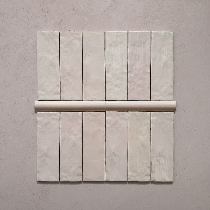 Zellij Pink Mist bullnose trim tile, 3cm x 20cm, soft blush pink tone, glossy glazed finish, smooth rounded edge, handcrafted Moroccan style.