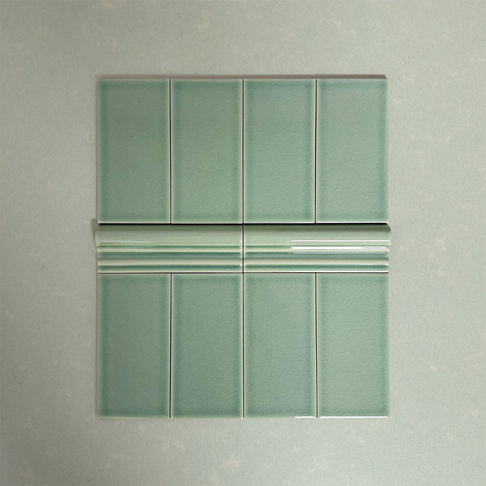 Flat lay showing Finchley Lime Green 7.5 × 15cm ceramic wall tiles with a crackle glaze finish, paired with matching 5 × 15cm dado trim to create a decorative, classic brick-style wall tile layout.