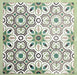 Group of Europa Budapest 20x20cm Victorian Moroccan style tiles arranged together to showcase the repeating geometric pattern in green, cream, black and taupe tones, displayed against a textured green background.