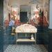 Bathroom featuring Cabana Bayamo 20x20cm Moroccan-style patterned floor tiles, paired with dark teal wall tiles, decorative wallpaper and an elegant marble washbasin with brass accents.
