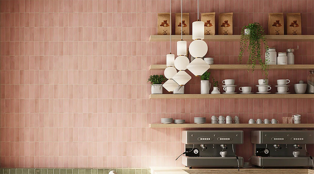 Café interior featuring Atlas Pink Mini Brick 5x15cm matt wall tiles, laid in a vertical brick format to emphasise height and create a soft, rhythmic backdrop. The muted pink tone introduces warmth without overwhelming the space, while the matt finish keeps the overall look refined and understated.