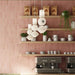 Café interior featuring Atlas Pink Mini Brick 5x15cm matt wall tiles, laid in a vertical brick format to emphasise height and create a soft, rhythmic backdrop. The muted pink tone introduces warmth without overwhelming the space, while the matt finish keeps the overall look refined and understated.