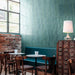 Madison Aquamarine Brick Wall Tiles 6x24.6cm — shown here in a stylish café setting, these glossy teal-green tiles bring depth and vibrancy to the space. Their handcrafted appearance and reflective surface create a lively, modern look that pairs beautifully with natural wood and industrial details.
