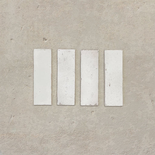 Close-up of Fusion Bricks Chalk White 6.5x20cm brick wall tiles, showcasing soft white tones with subtle tonal variation and a lightly textured surface, highlighting a clean, handcrafted finish.
