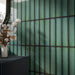 Chemistry Green 6.5cm x 30cm wall tiles, showcasing vibrant green tones, dark contrasting edges and a glossy finish that catches the natural light.