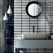 Bathroom setting featuring Chemistry White 6.5cm x 30cm rectangular ceramic wall tiles, installed in a stacked layout with a glossy crackle-effect white glaze and dark grout for a contemporary, artisan finish.