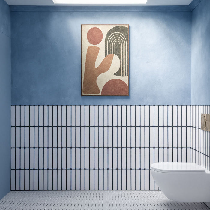 Chemistry White 6.5cm x 30cm wall tiles installed vertically across the lower half of a modern bathroom wall, featuring a crisp white finish with contrasting dark blue edges, paired with soft blue walls and a white wall-mounted toilet.