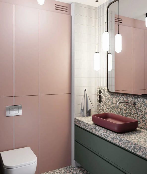 Modern bathroom featuring Chunks POP Terrazzo Green 60 × 120cm terrazzo-effect porcelain wall and floor tiles, paired with deep green cabinetry, a burgundy basin, ribbed glass shower screen, and soft contemporary lighting.