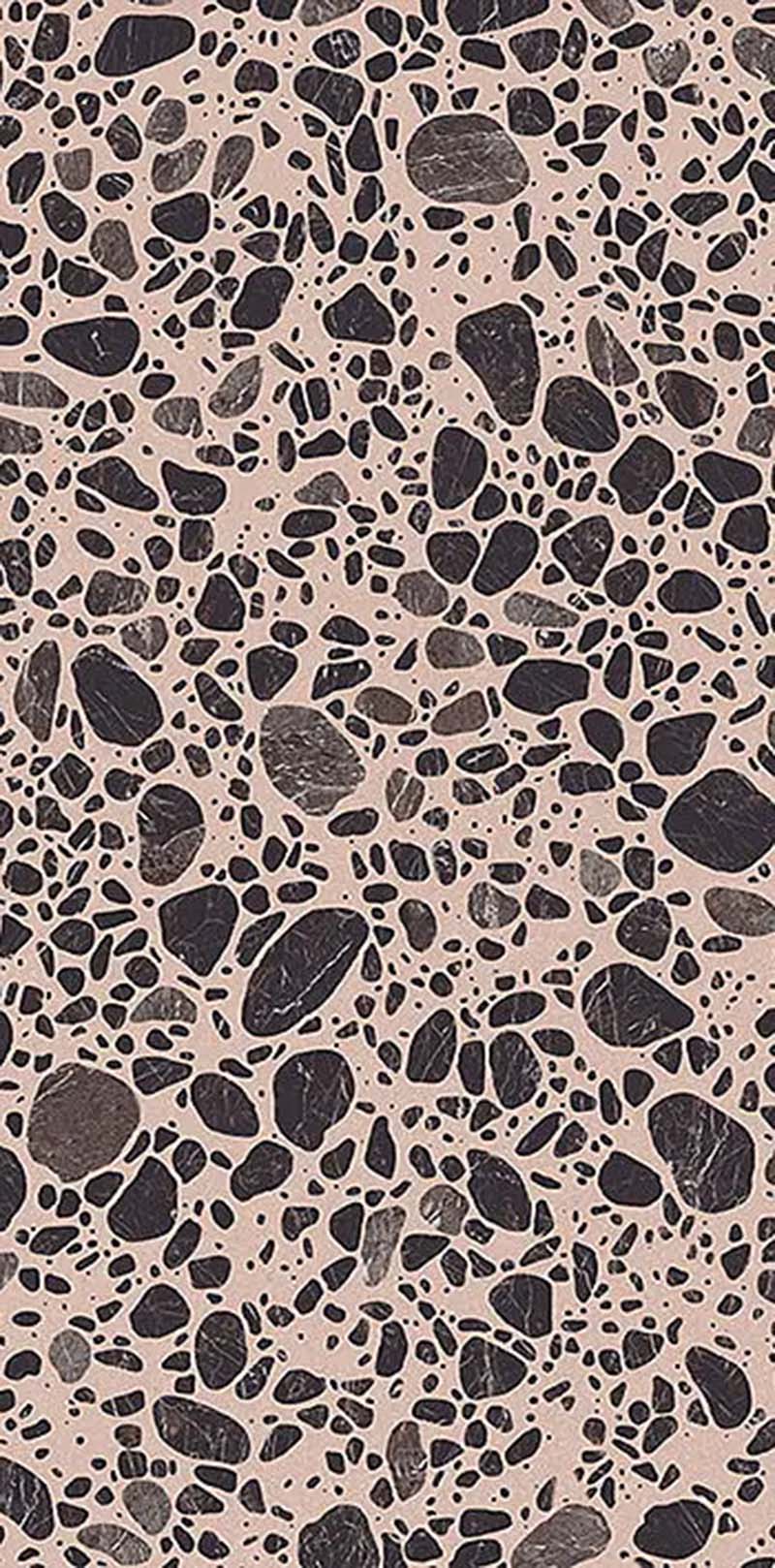 Close-up of Chunks Pop Pink 60cm x 120cm terrazzo effect porcelain tile, featuring a soft pink background with black and grey stone-inspired aggregates for contemporary wall and floor designs.