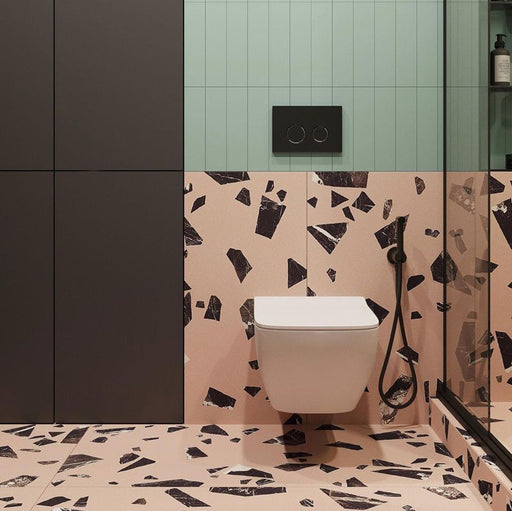 Contemporary bathroom featuring Chunks Rock Pink 60cm x 120cm terrazzo effect porcelain wall and floor tiles, paired with mint green wall tiles, black brassware, a walk-in shower and minimalist furnishings.