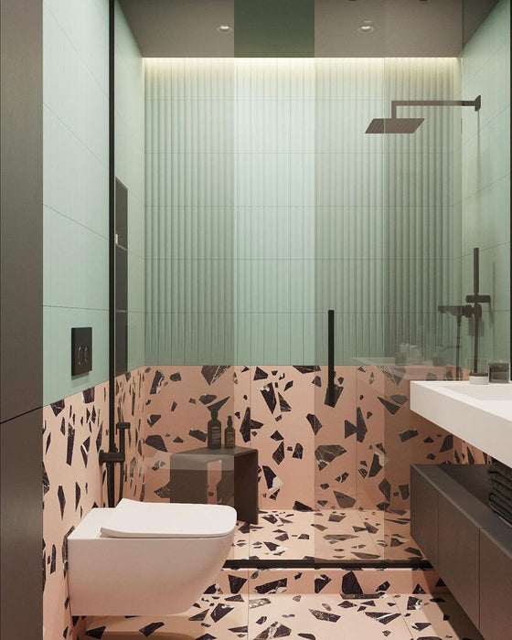 Contemporary bathroom featuring Chunks Rock Pink 60cm x 120cm terrazzo effect porcelain wall and floor tiles, paired with mint green wall tiles, black brassware, a walk-in shower and minimalist furnishings.