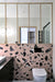 Modern bathroom featuring Chunks ROCK Terrazzo Pink 60 × 60cm terrazzo-effect porcelain wall tiles, showcasing oversized black marble-inspired fragments, paired with minimalist black fittings and light wood framed mirrors.
