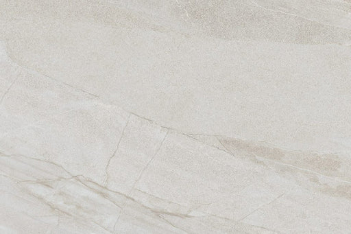 Flat lay of Cocoon Stone Light 2cm 60 × 90cm porcelain tile, highlighting soft light beige stone effect tones with gentle, flowing veining and a fine textured surface. Subtle variation creates a bright, natural finish suitable for both indoor and outdoor spaces.