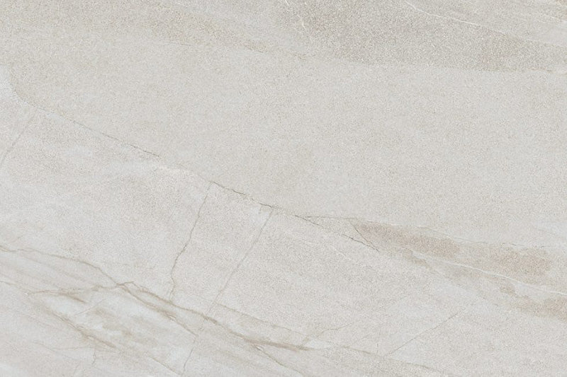 Flat lay of Cocoon Stone Light 2cm 60 × 90cm porcelain tile, highlighting soft light beige stone effect tones with gentle, flowing veining and a fine textured surface. Subtle variation creates a bright, natural finish suitable for both indoor and outdoor spaces.