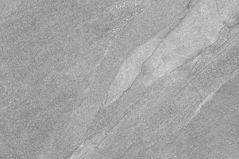 Flat lay of Cocoon Stone Silver 2cm 60 × 90cm porcelain tile, highlighting cool silver-grey stone effect tones with gentle veining and a fine, lightly textured surface. Subtle variation creates a clean, contemporary finish suitable for indoor and outdoor spaces.
