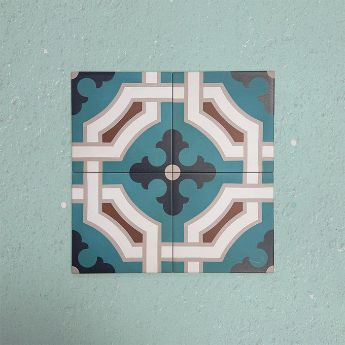Four Europa Cologne 20x20cm Victorian Moroccan style tiles arranged together to showcase the repeating geometric pattern in teal, brown, cream and dark blue tones, displayed against a textured aqua background.