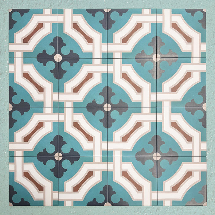 Group of Europa Cologne 20x20cm Victorian Moroccan style tiles arranged together to showcase the repeating geometric pattern in teal, brown, cream and dark blue tones, displayed against a textured aqua background.