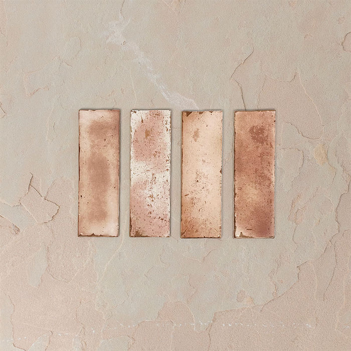 Close-up of Fusion Bricks Coral Pink 6.5x20cm brick wall tiles, showcasing soft tonal variation and lightly textured surface, highlighting warm blush tones and natural variation for a subtle, handcrafted look.